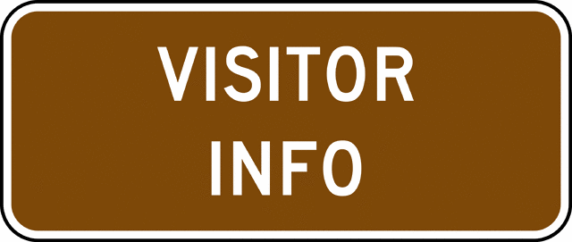 Brown rectangular sign with white uppercase text "VISITOR INFO" indicating a visitor information center or kiosk location.