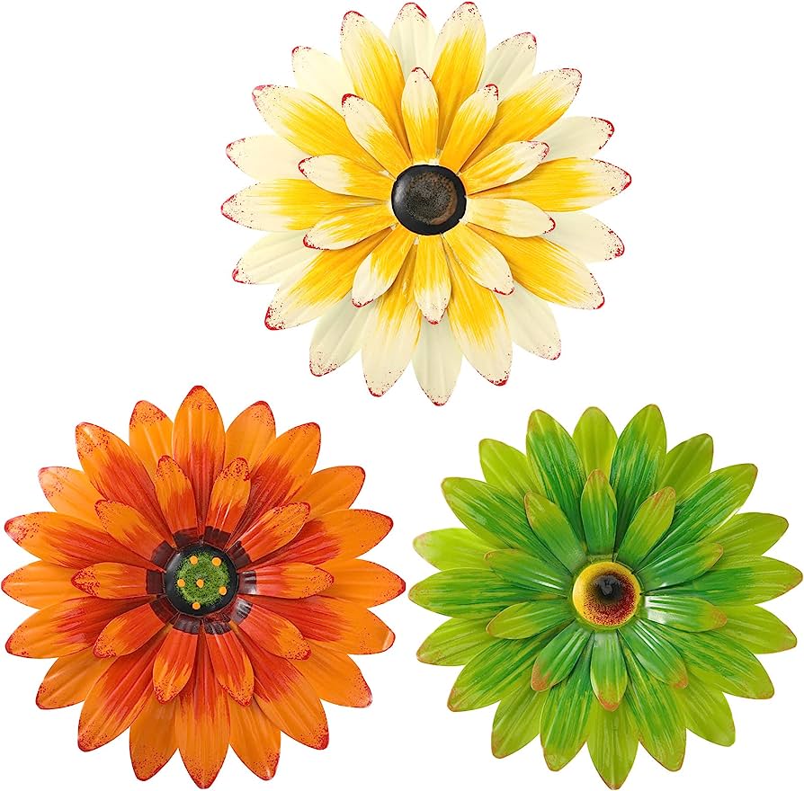 Three colorful metal daisy-style wall art flowers in yellow-white, orange-red, and green with detailed centers.