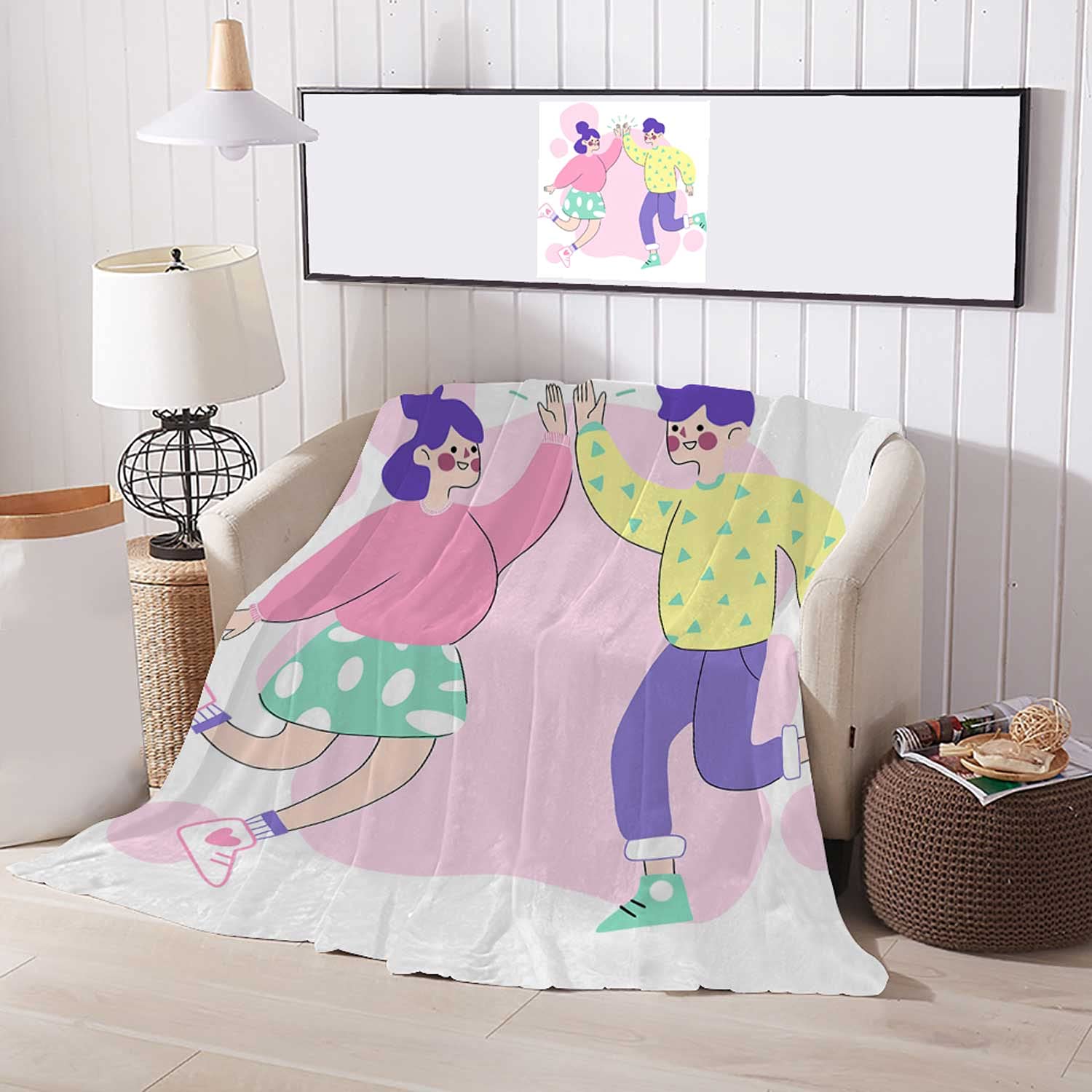 Colorful illustrated blanket featuring two joyful cartoon characters high-fiving, draped over a cozy armchair in a modern living room.
