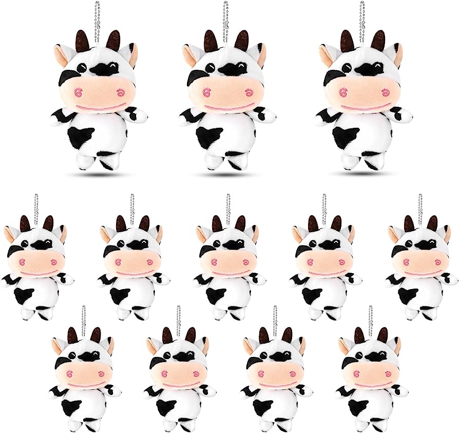 Twelve adorable black-and-white cow plush keychains with smiling faces and hanging chains, arranged in three rows.