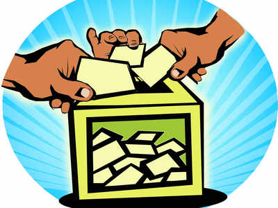 Hands casting ballots into a green voting box with rays of light behind, symbolizing democratic participation.