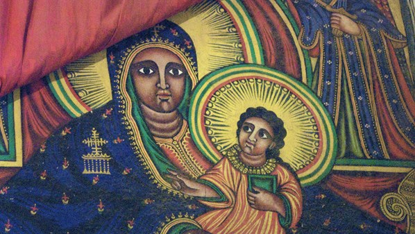 Ethiopian Orthodox icon of the Virgin Mary holding the Christ Child, rich in color and symbolic detail.