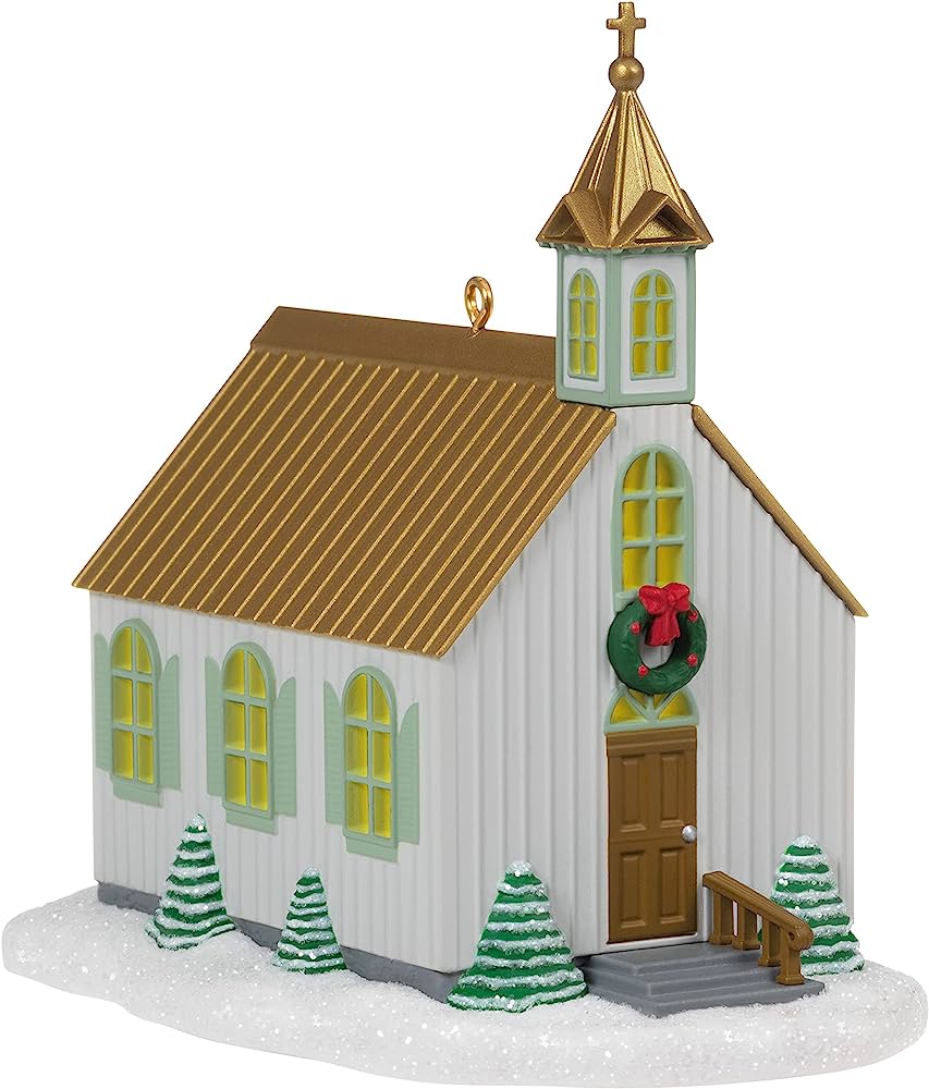 Decorative Christmas church ornament with gold roof, green wreath, and snowy miniature trees.