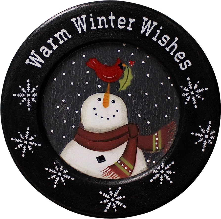 Black decorative plate with "Warm Winter Wishes" text, snowman wearing scarf, red cardinal on nose, snowflakes and snowy background.