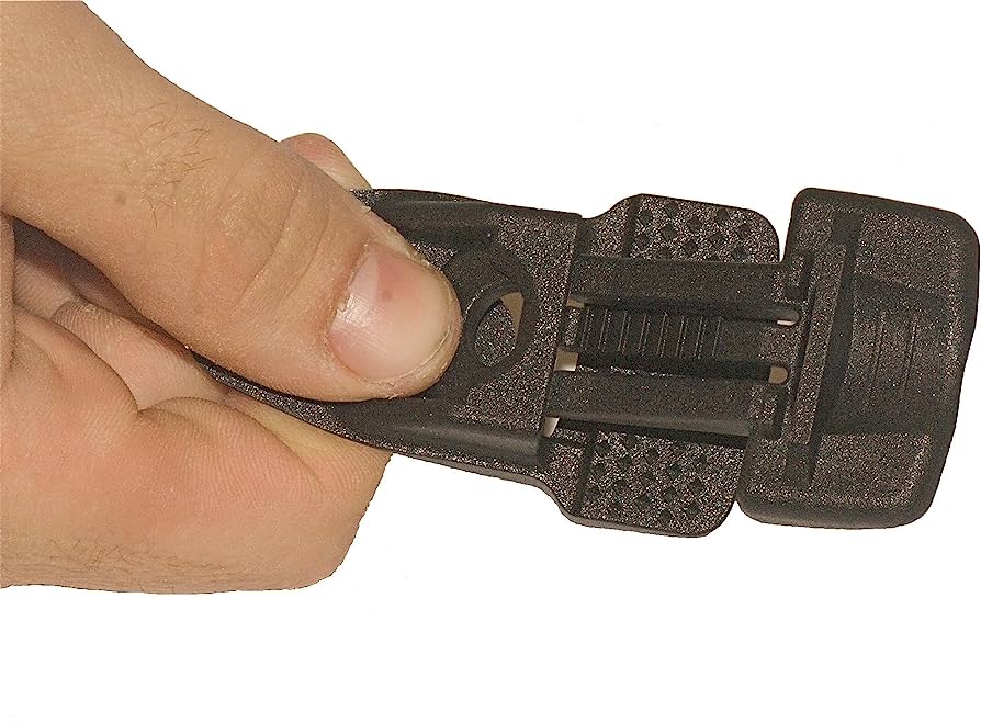 Close-up of a hand operating a black plastic side-release buckle with textured grip surfaces.