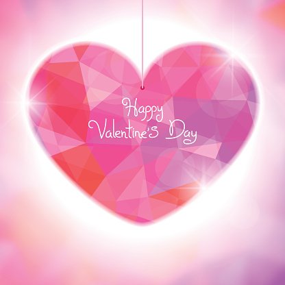 Shimmering pink and red faceted heart with "Happy Valentine's Day" text, suspended on a string against soft bokeh background.