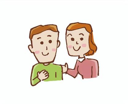 A smiling man in a green shirt and woman in pink, standing close with gentle hand gestures, conveying support and empathy.