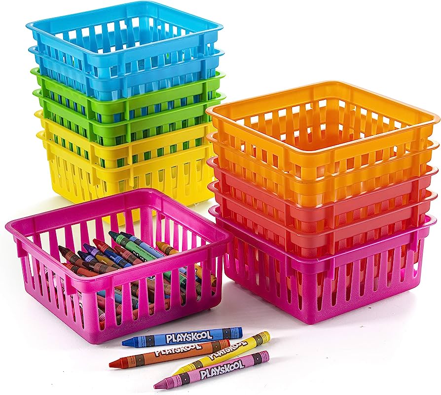 Colorful plastic storage baskets in rainbow hues, some filled with crayons, ideal for classroom or craft organization.