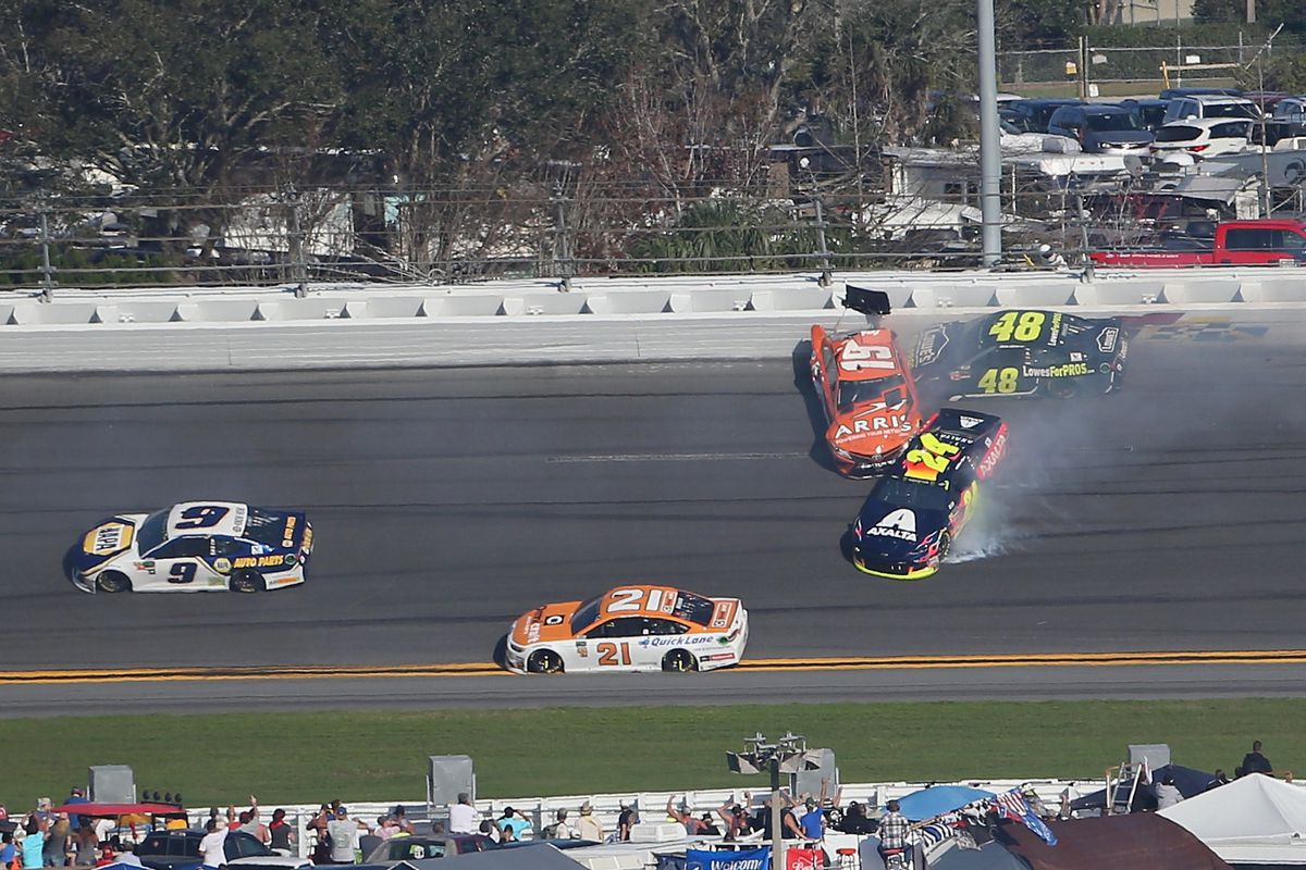 NASCAR race crash involving cars #19, #48, #24, with #9 and #21 avoiding collision on track.