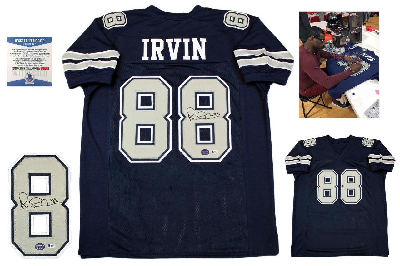 Autographed Dallas Cowboys #88 Michael Irvin jersey with Beckett COA and signing photo.