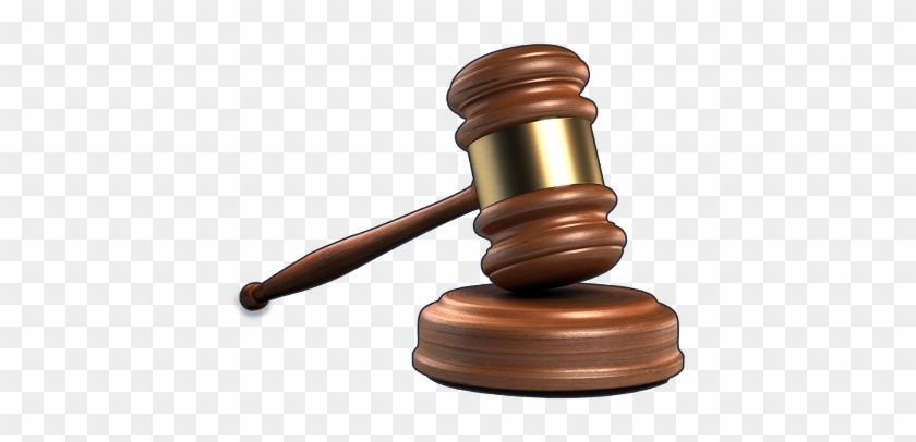 Wooden judge's gavel resting on its sound block, symbolizing legal authority and courtroom proceedings.