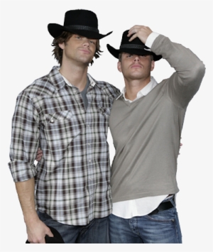 Two men in cowboy hats posing together, one in plaid shirt, the other in gray sweater over white collared shirt.