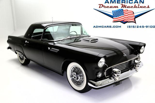 Black 1956 Ford Thunderbird convertible with white-wall tires and chrome details, studio shot.