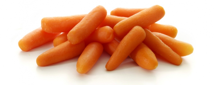 A fresh pile of bright orange baby carrots on a clean white background.