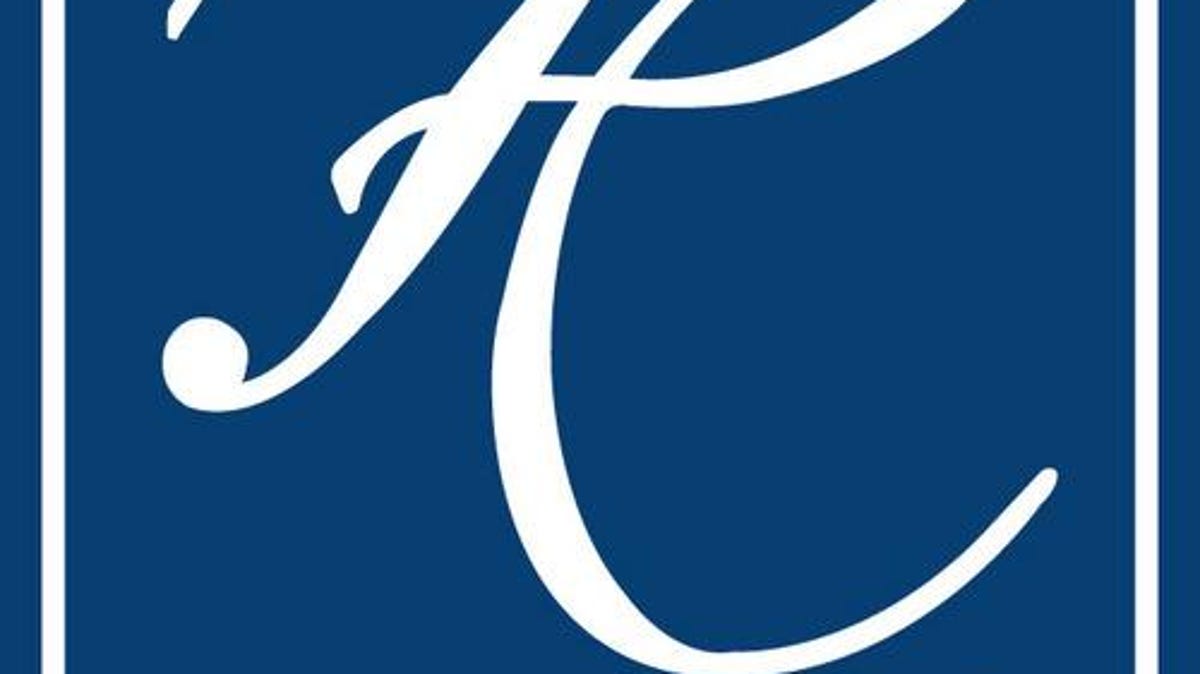 Stylized white cursive letter "K" on a deep blue background with vertical white borders.