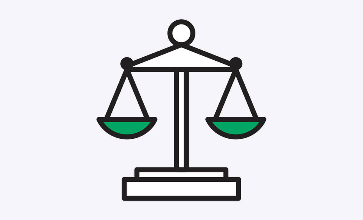 Balanced justice scales with green weights, symbolizing fairness and legal equity.