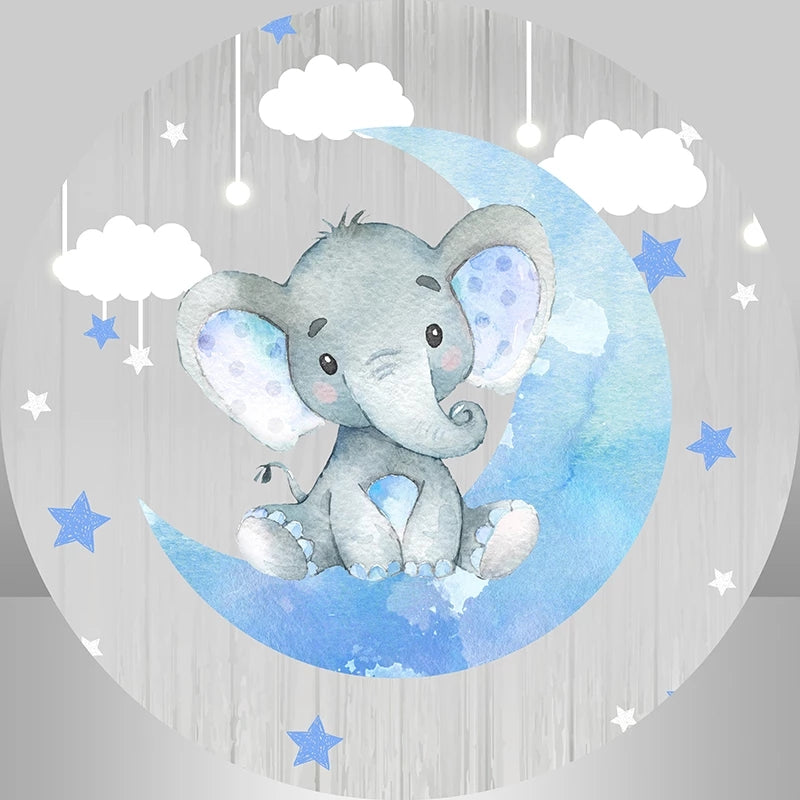 Cute watercolor baby elephant sitting on a blue crescent moon with stars and clouds in a dreamy nursery scene.