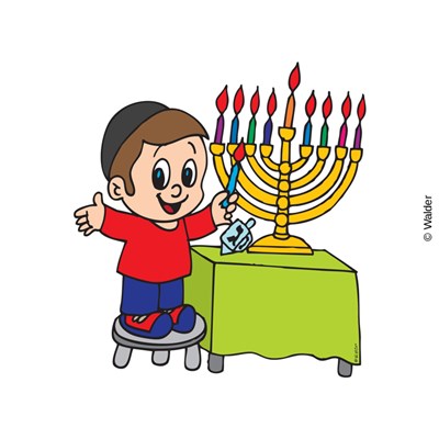 A smiling boy in a kippah lights a colorful Hanukkah menorah with a dreidel nearby.