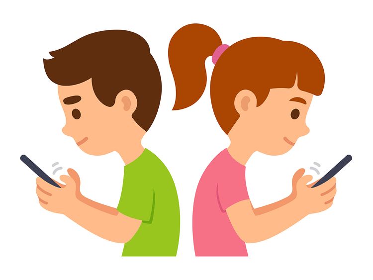 A boy in green and a girl in pink stand back-to-back, both smiling while using smartphones.