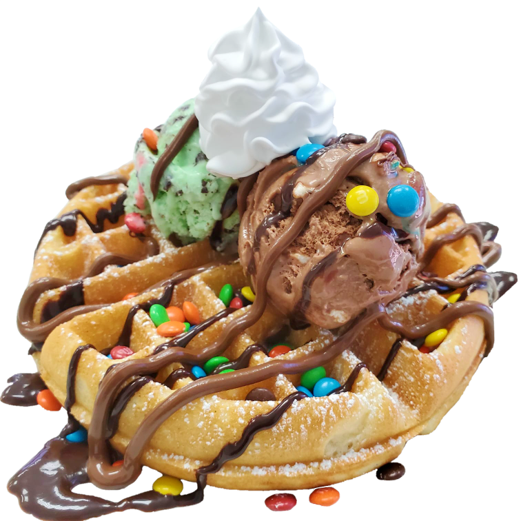 Golden waffle topped with chocolate and mint ice cream, M&Ms, chocolate drizzle, whipped cream, and powdered sugar.