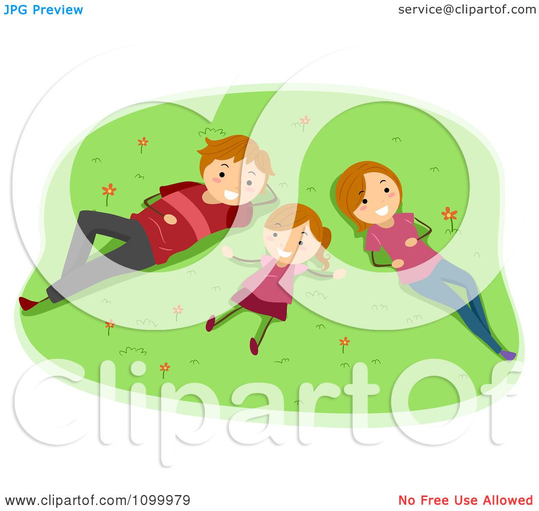 A happy family of three-father, mother, and daughter-lying on green grass with flowers, smiling and relaxing outdoors.