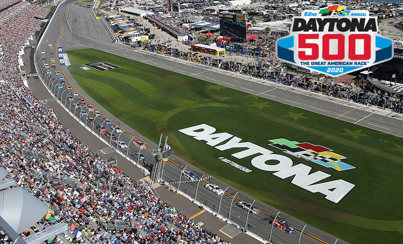 Aerial view of the 2020 Daytona 500 race with packed grandstands, cars on the track, and "DAYTONA" painted on infield grass.