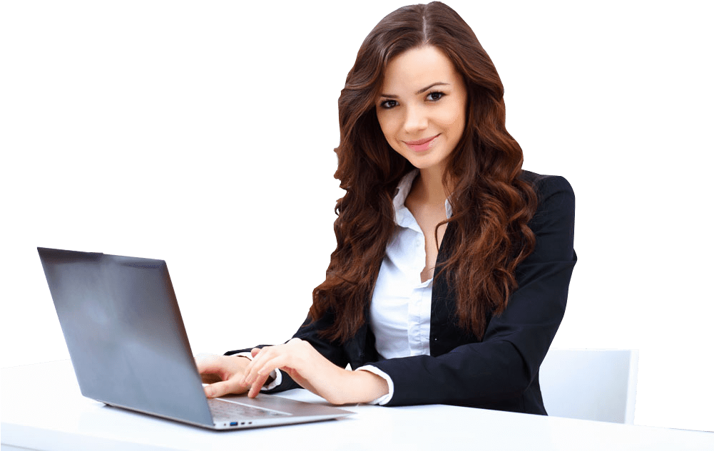 Professional woman with long brown hair working on a laptop at a white desk, smiling confidently.