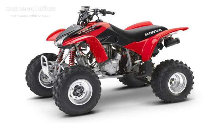 Red and black Honda TRX450R sport ATV with knobby tires and exposed engine on white background.
