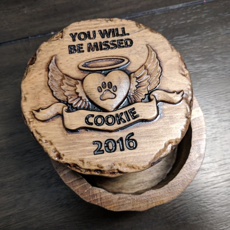 Wooden pet memorial box lid engraved with "You Will Be Missed", angel wings, heart paw print, name "Cookie", and year "2016".