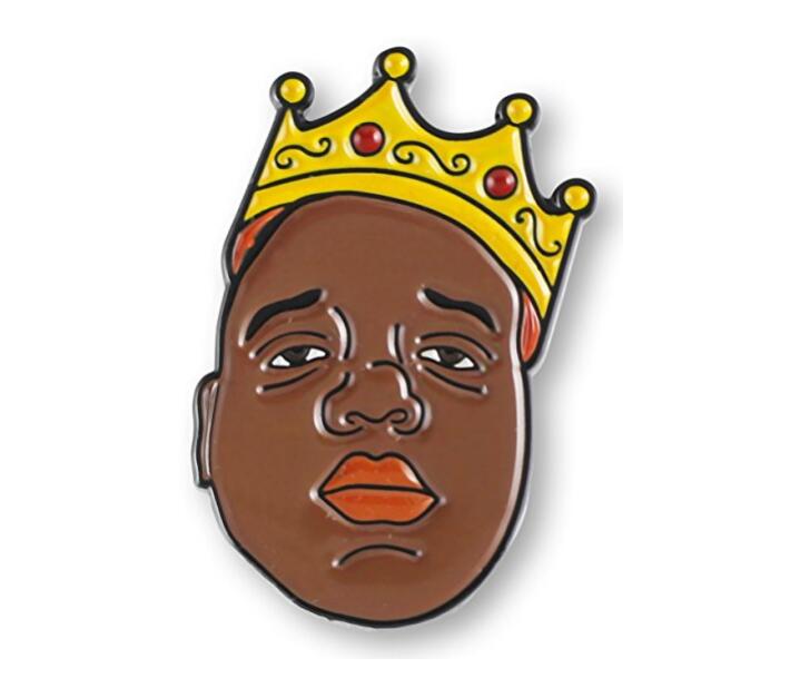 Enamel pin featuring a stylized portrait of The Notorious B.I.G. wearing a golden crown with red jewels.