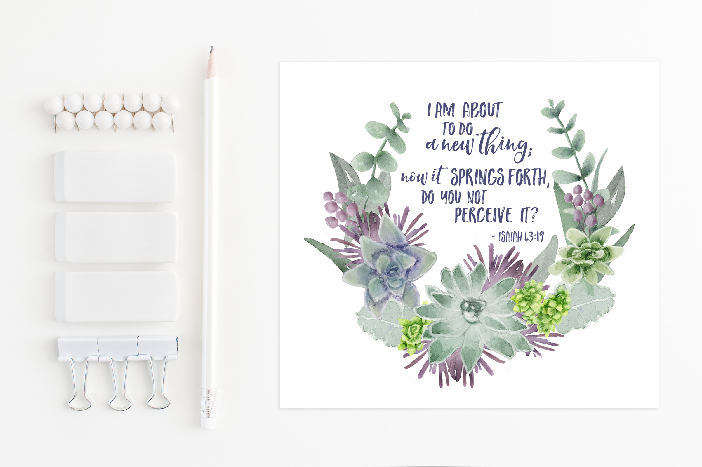 Watercolor succulent wreath with Isaiah 43:19 verse, alongside white stationery items including pencil, erasers, clips, and pins.