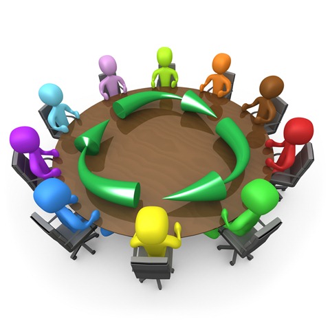 Colorful 3D figures seated around a circular table with green arrows showing collaborative workflow.