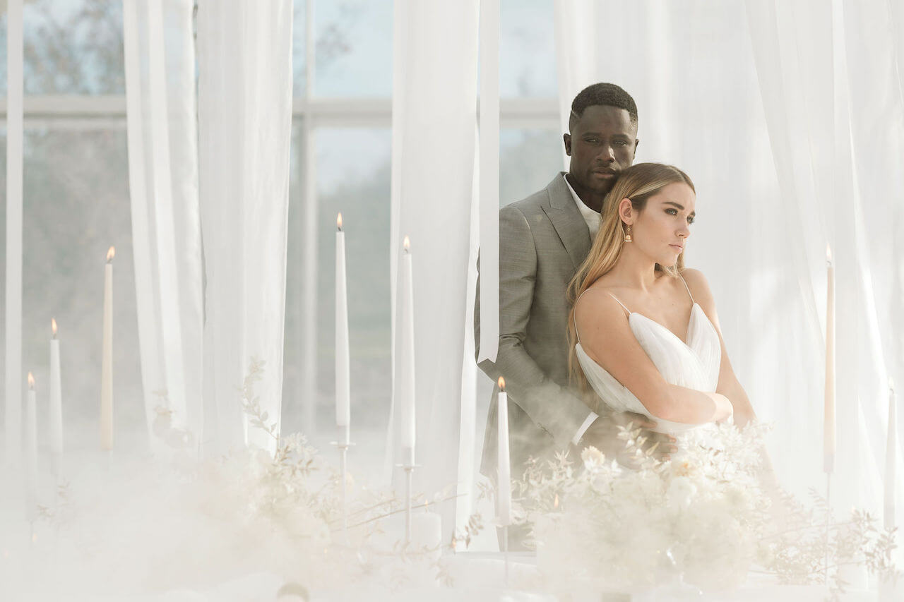 Elegant Interracial Wedding Portrait with Ethereal Candlelight Setting