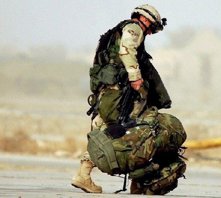 Soldier Assisting Fallen Comrade - Military Valor and Camaraderie