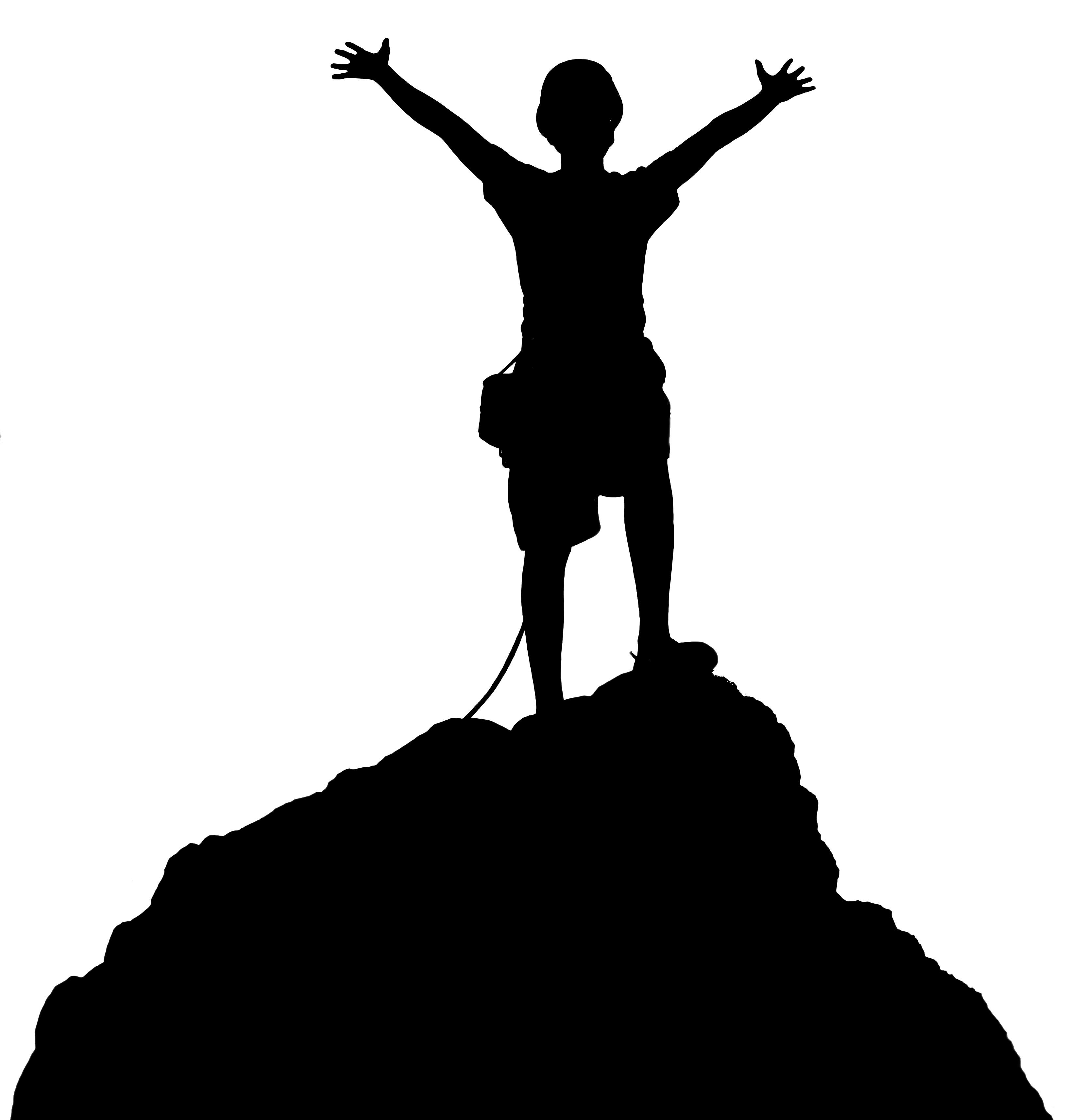 Silhouette of a person standing triumphantly atop a rocky peak with arms raised high, symbolizing achievement and freedom.