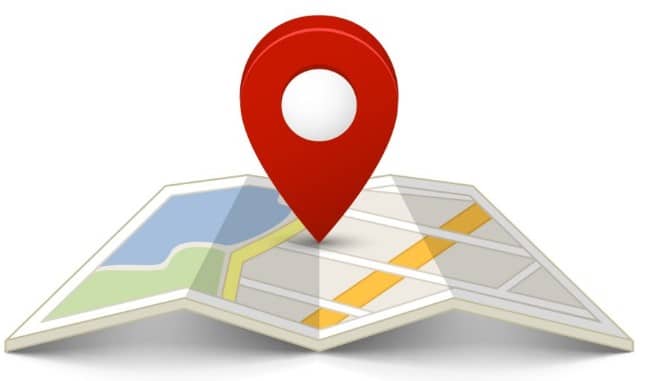 Red location pin centered on a folded paper map with roads, water, and green areas.