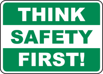 Green safety sign with bold white text reading "THINK SAFETY FIRST!" in three horizontal bands.