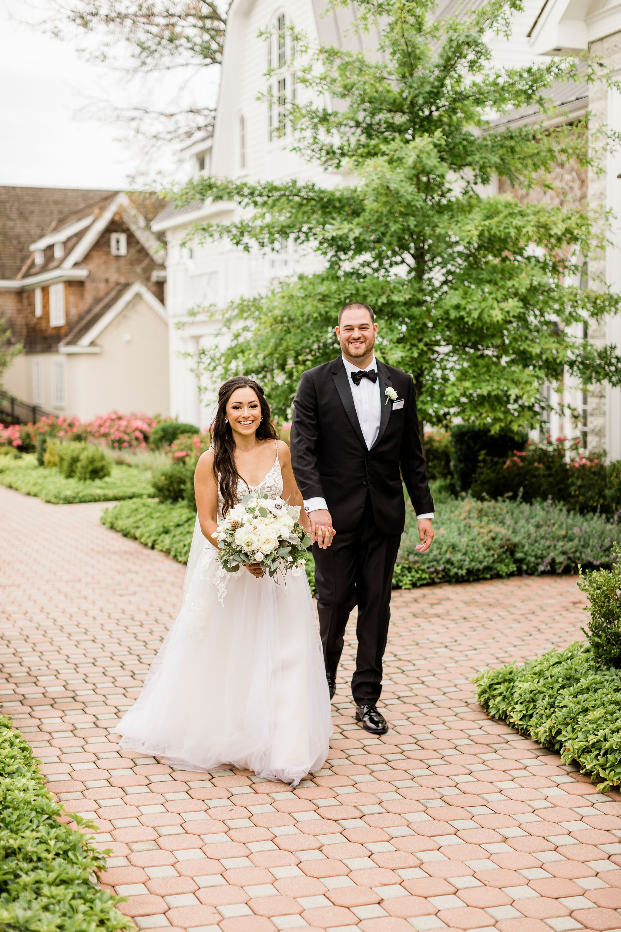 Elegant Wedding Couple Walking Through Garden Path | Bridal Photography