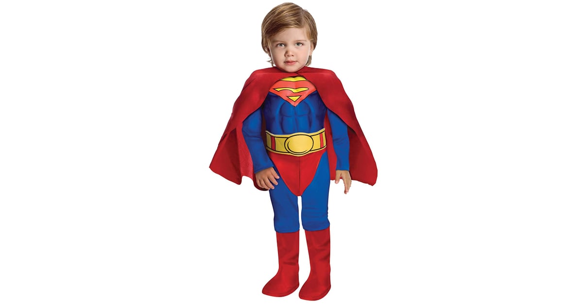 Toddler wearing a classic Superman costume with red cape, blue suit, yellow belt, and iconic S-shield logo.