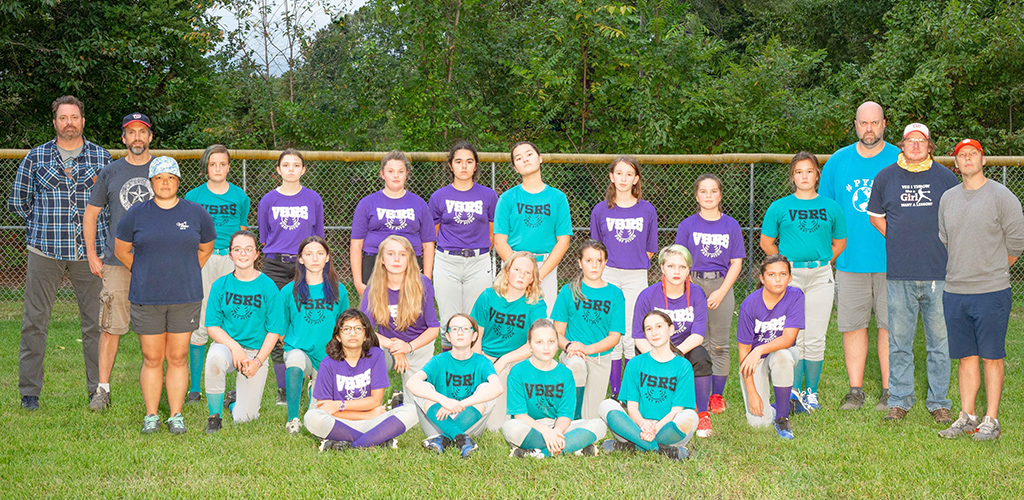 Youth softball team and coaches posing outdoors in matching purple and teal uniforms with "VSRS" logos.