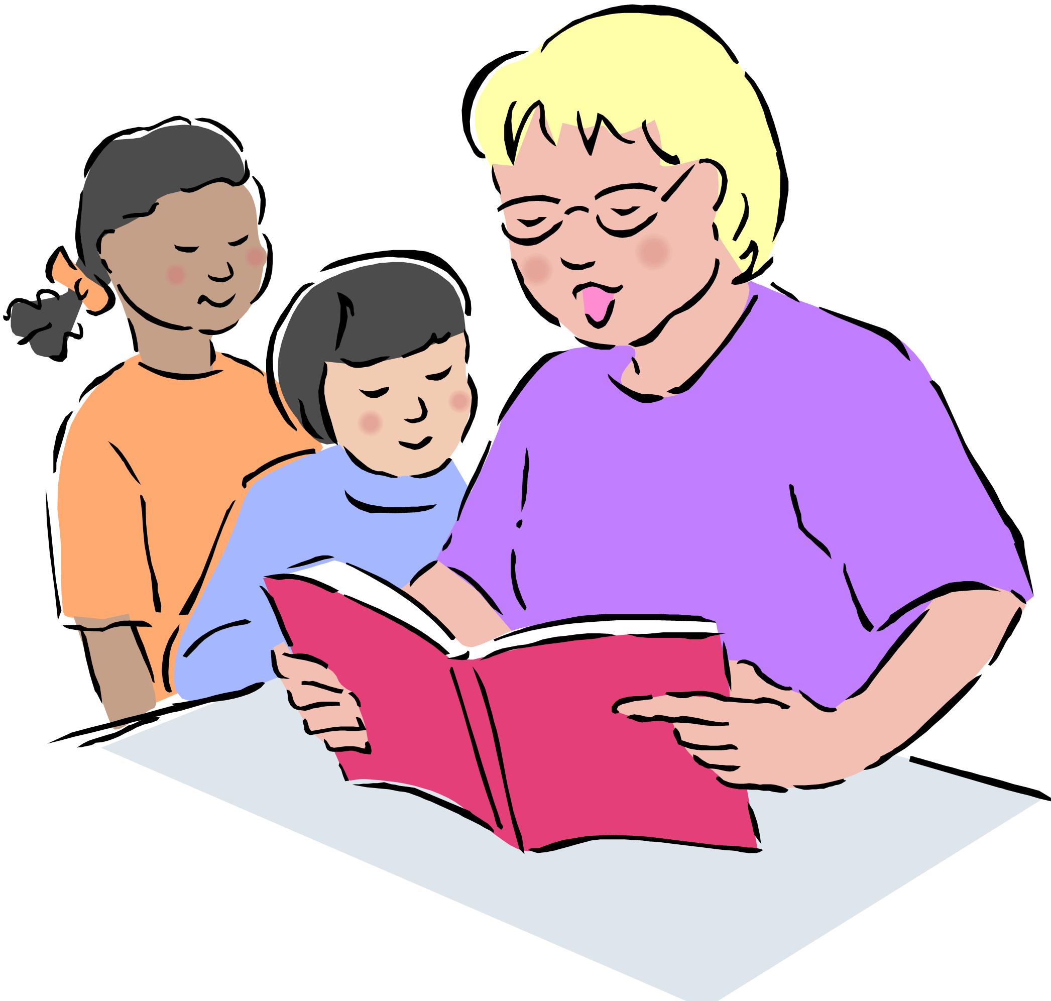 Teacher reading aloud from a red book to two attentive students at a table.