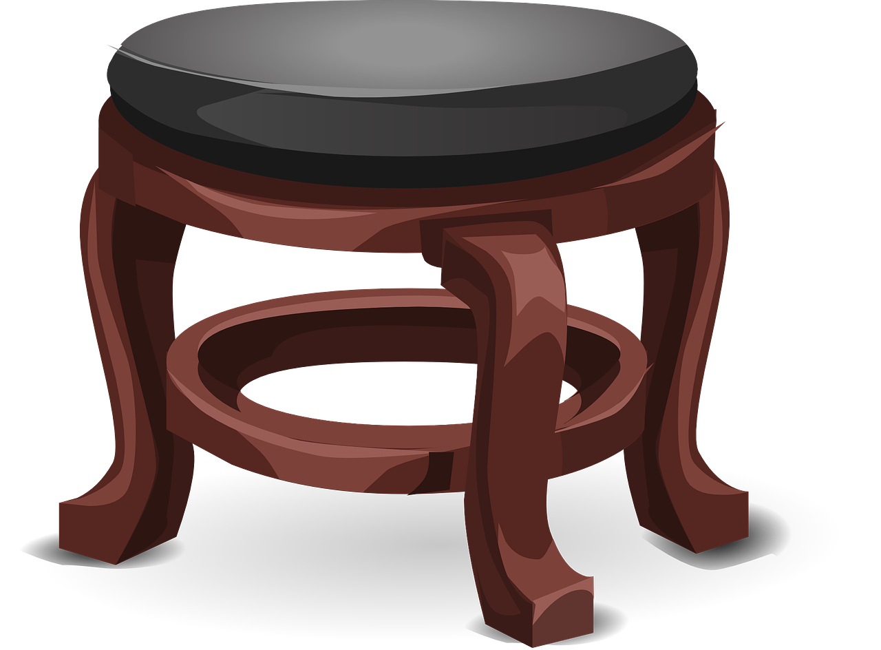 Classic wooden stool with black cushioned seat and ornate carved legs, featuring a circular footrest.