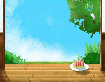A plate of watermelon slices on a wooden porch, with green trees and blue sky visible through an open doorway.