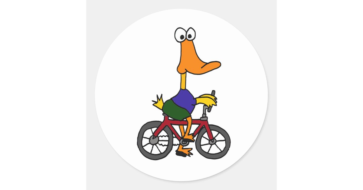 Cartoon duck wearing purple shirt and green shorts riding a red bicycle with big eyes and orange beak.