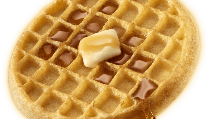 Golden waffle with butter and syrup in a grid pattern, close-up shot.