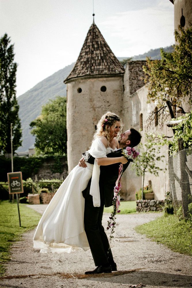 Rustic Castle Wedding Photography - Joyful Bridal Lift Moment