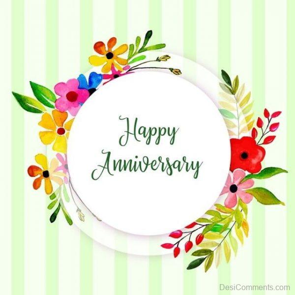 Colorful floral wreath surrounding "Happy Anniversary" text on green-striped background.