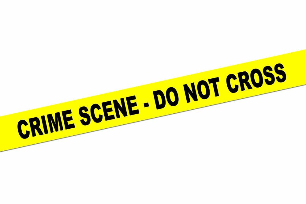 Yellow crime scene tape with bold black text reading "CRIME SCENE - DO NOT CROSS" on a white background.