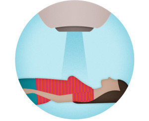 Person lying down receiving targeted light therapy from an overhead medical device.