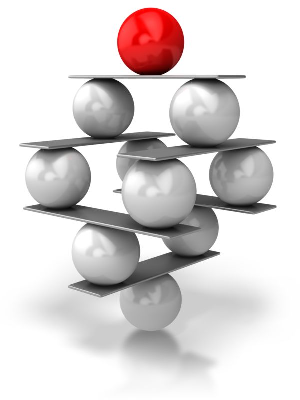 A red sphere balances atop a precarious pyramid of silver spheres and metal plates, symbolizing leadership or critical priority.